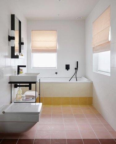 Minimalist bathrooms with terra cotta tile and roman shades