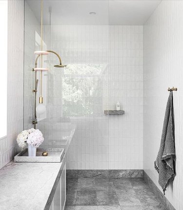 natural limestone vanity top and dark stone tiles in stone tile bathroom