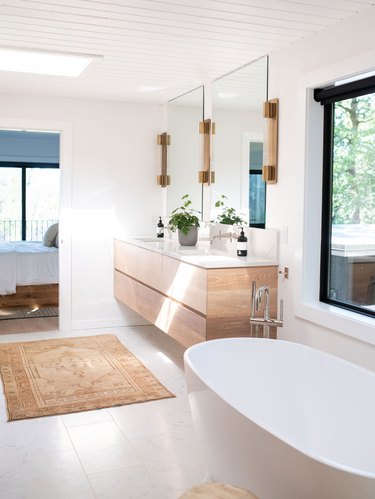 bathroom wall lighting idea with wall sconces on either side of frameless mirrors
