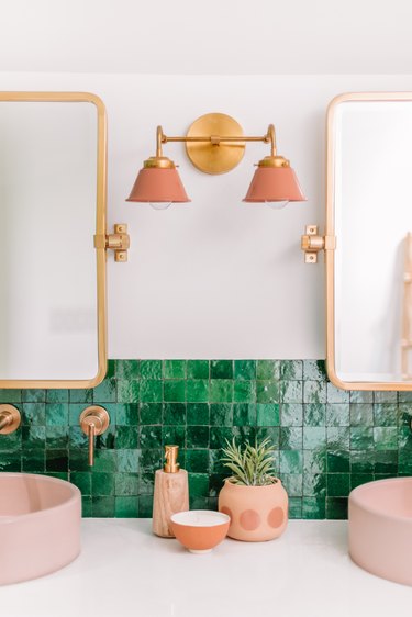 pink and brass bathroom wall lighting idea with double wall sconce