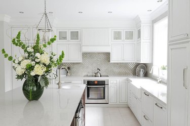kitchen with white kitchen floor tiles, recessed light. and florals