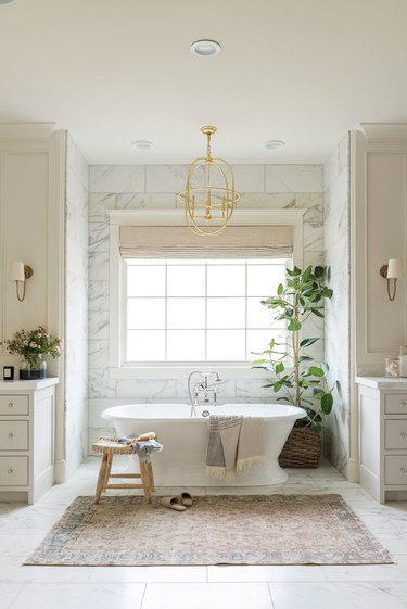 white bathroom with golden chandelier.