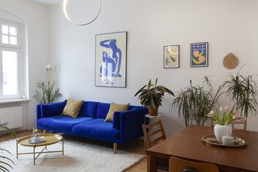 Midcentury modern living room with vintage furniture and blue couch