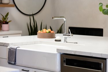 single-handle kitchen faucet and farmhouse sink in kitchen island