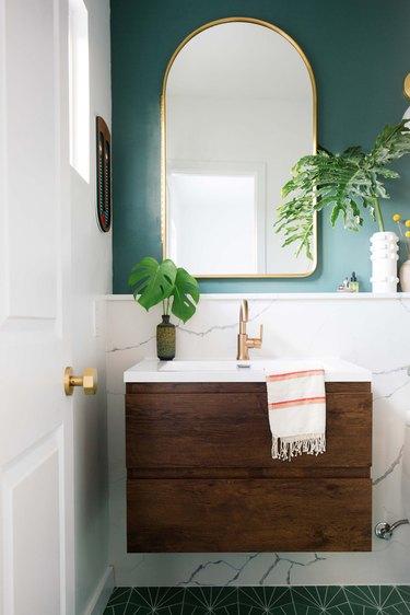 bathroom mirror idea with green and marble bathroom with wooden vanity and gold arch mirror