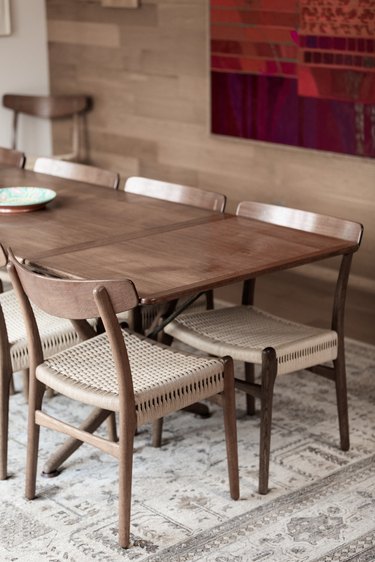 Mid-century dining table compliments the white oak walls.