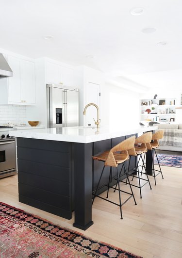 kitchen bar idea with slick kitchen with black and white island and rattan bar stools