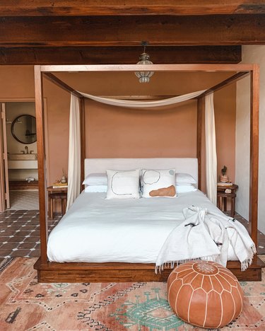 terracotta and clay desert house color palette in bedroom with canopy bed