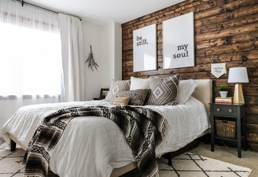 rustic bedroom with dark wood shiplap accent wall