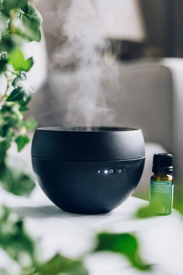 Mist coming from black essential oil diffuser