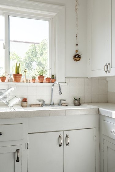 minimalist bohemian kitchen with terracotta plant pots