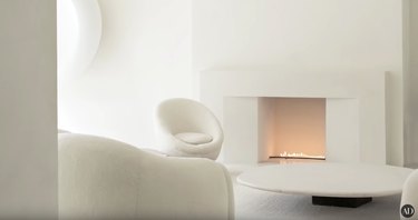living space with all white walls and white furniture, with fireplace