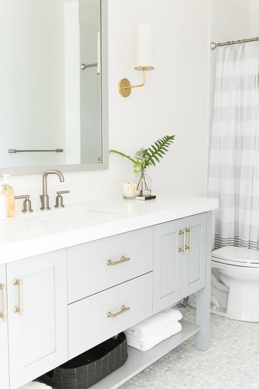 bathroom space with a vanity and square mirror