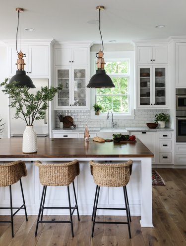 white farmhouse kitchen with black industrial pendant lights above island