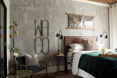 rustic bedroom with textured gray accent wall