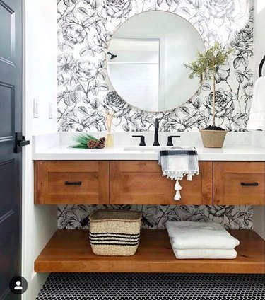 bathroom with floral wallpaper and floating vanity