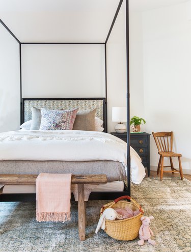 boho girls room with four poster bed with florals