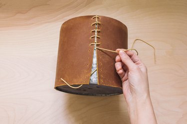 Wrapping and stitching leather onto tin planter