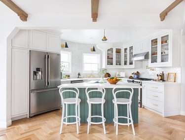 White, wood and sagey blue kitchen with island