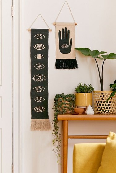 boho wall decor idea with black and white eyes wall hanging