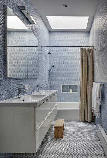 modern bathroom with penny tile and skylight