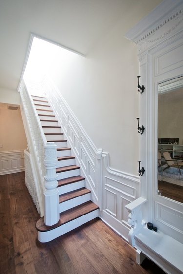 brownstone staircase with skylight and coat hooks entryway