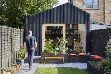 Modern shed with linear black panel exterior and natural wood accents