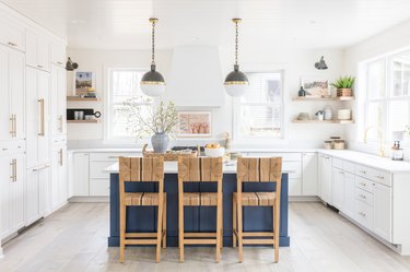 Coastal kitchen island table with woven chairs