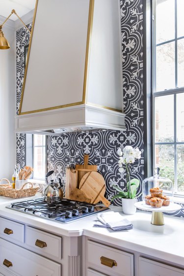 Art deco kitchen with brass accents and art deco tile backsplash