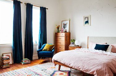 guest bedroom idea with blue drapery and matching side chair