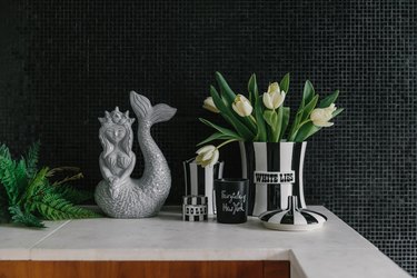 Jonathan Adler accessories and tulips in bathroom