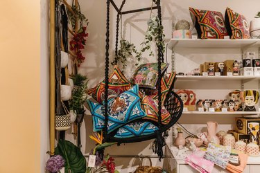 hanging woven chair with silken favours cushions