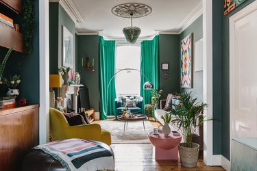 green living room with colourful furniture and large bay window