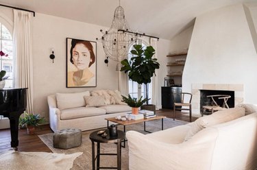 family room furniture with white slipcovered couches and iron chandelier