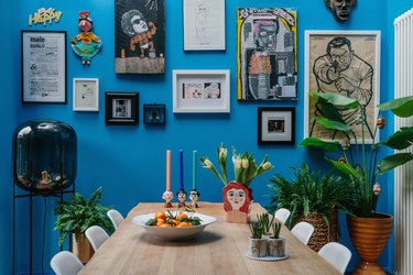 bright blue dining room with gallery wall