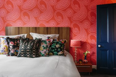 cosy bedroom with red paisley wallpaper