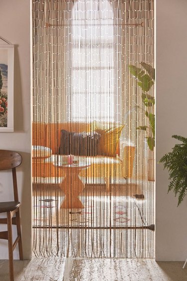 bamboo curtain leading into room with couch