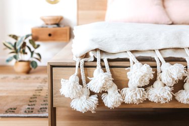 pom poms on blanket in bedroom