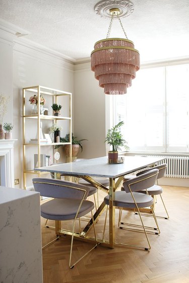 pink and taupe dining room with art deco chairs and fringe chandelier