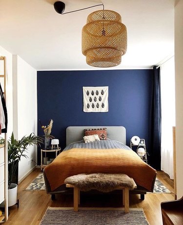 blue bohemian bedroom with IKEA pendant and mustard bedspread