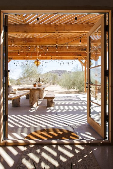 patio dining area with pergola and French doors