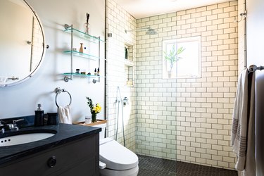 bathroom space with white tiled shower