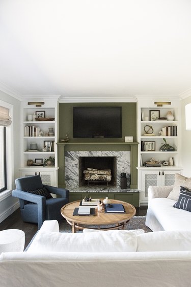 white living room with green fireplace