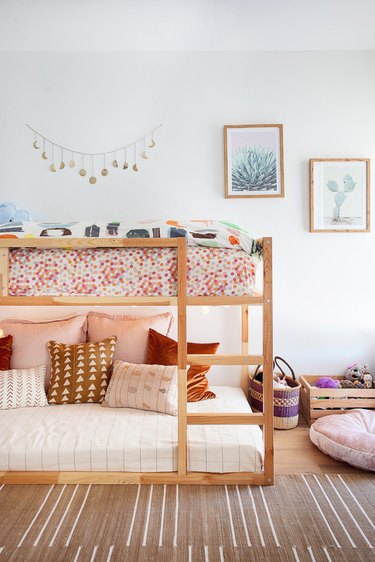 boho minimalist girl bedroom with bunk bed and striped rug