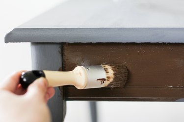 Applying antique wax to end table