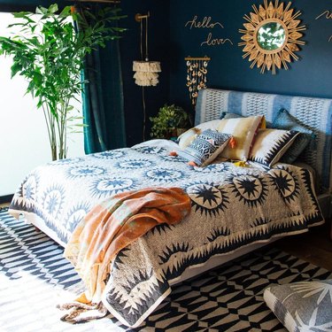 blue bohemian bedroom idea with patterned headboard and bedding