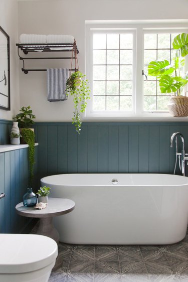 arts and crafts bathroom with freestanding tub and painted beadboard