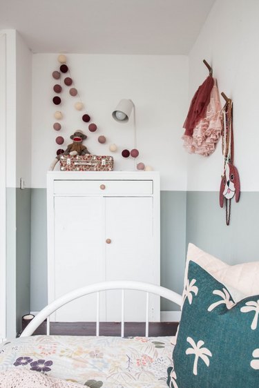 white and green minimalist girl bedroom with white dresser