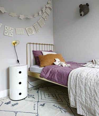 minimalist girl bedroom with brass bed