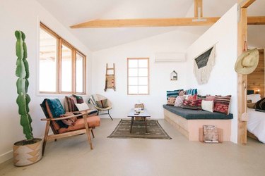 polished concrete foundation in modern homesteaders cabin living room bedroom in california desert
